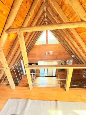 a attic room with a wooden ceiling with a window at Glamping en Rionegro in Rionegro