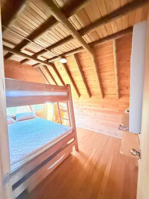 a bedroom with a bed in a wooden room at Glamping en Rionegro in Rionegro