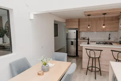 a kitchen and dining room with a table and chairs at Apartamento en Rionegro, Cerca al aeropuerto JMC in Rionegro