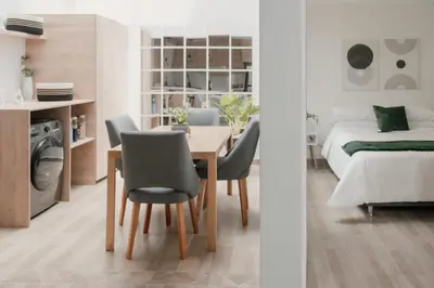 a bedroom and a dining room with a table and chairs at Apartamento en Rionegro, Cerca al aeropuerto JMC in Rionegro