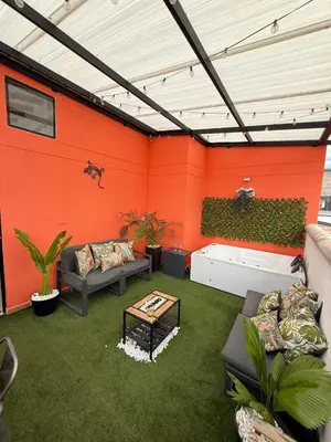 an outdoor patio with a couch and a table at Lujoso pent-house de dos niveles in Itagüí