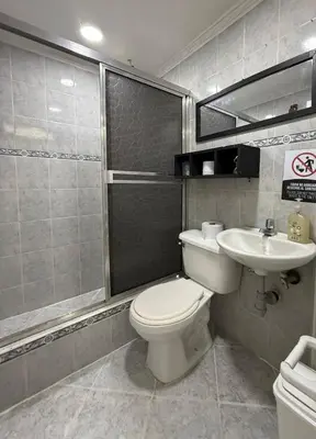 a bathroom with a toilet and a sink at Apartamento en Belén San Bernardo, Medellín in Medellín