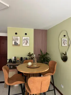 a dining room with a wooden table and chairs at Hermosa habitación con excelente ubicación in Medellín