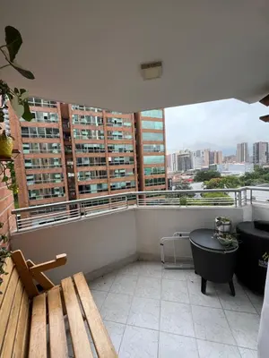 a balcony with a bench and a view of a city at Hermosa habitación con excelente ubicación in Medellín