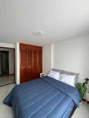 a bedroom with a blue bed in a room at Hermosa habitación con excelente ubicación in Medellín