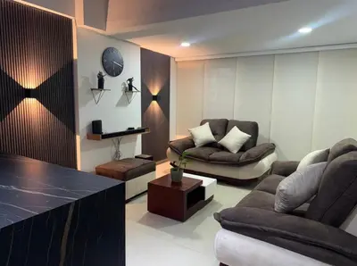 a living room with two couches and a table at Full apartment in Laureles in Medellín
