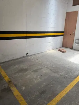 an empty parking garage with a door and a parking lot at Full apartment in Laureles in Medellín