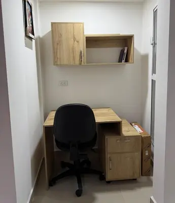 a desk with a black chair in a room at Full apartment in Laureles in Medellín