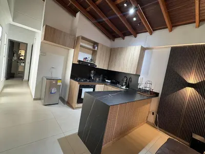 a kitchen with a black counter top in a room at Refugio en laureles in Medellín