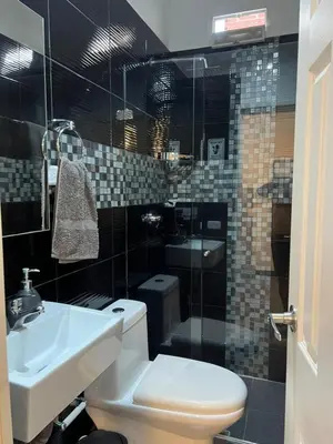 a bathroom with a toilet and a sink at Casa Florez in Medellín