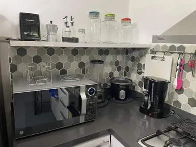 a kitchen with a counter top with a coffee maker at Casa Florez in Medellín