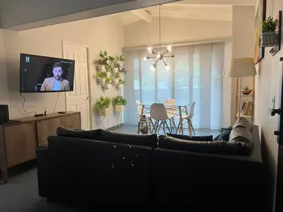 a living room with a couch and a tv at Casa Florez in Medellín