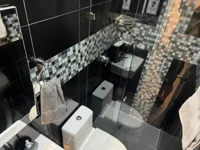 a bathroom with a toilet and a sink at Casa Florez in Medellín
