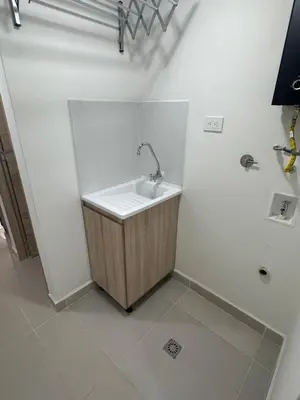 a white bathroom with a sink in a room at Apartamento laureles estadio 201 ED MILA in Medellín