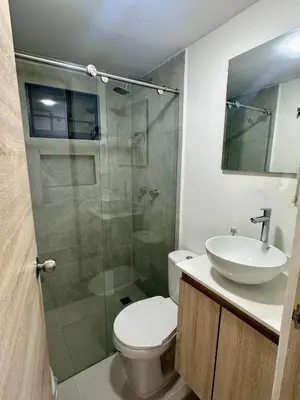 a bathroom with a shower and a toilet and a sink at Apartamento laureles estadio 201 ED MILA in Medellín