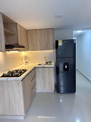 a kitchen with a black refrigerator and a stove at Apartamento laureles estadio 201 ED MILA in Medellín
