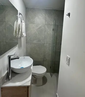 a bathroom with a toilet and a sink and a shower at Apartamento laureles estadio 201 ED MILA in Medellín