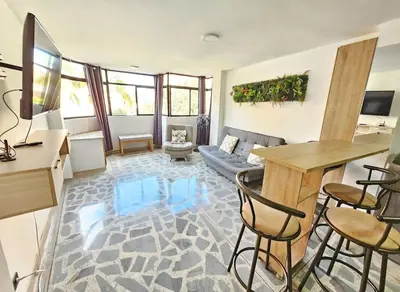 a living room with a couch and a table at Exclusive Stadium Apartment in Medellín