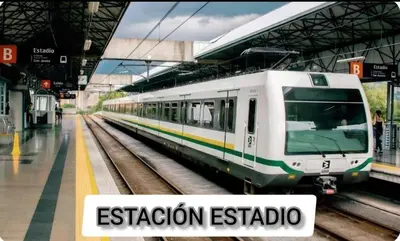 a white train on the tracks at a station at Exclusive Stadium Apartment in Medellín