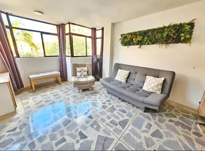 a living room with a couch and a chair at Exclusive Stadium Apartment in Medellín