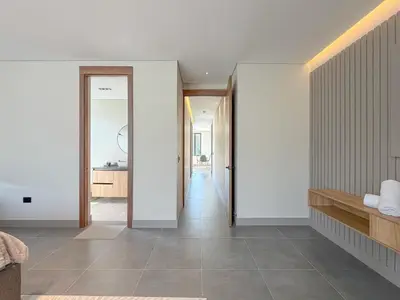 a hallway of a house with white walls and tile floors at Apartamento de lujo a 3 minutos del Aeropuerto JMC 301 in Rionegro