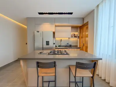 a kitchen with a large island with two bar stools at Apartamento de lujo a 3 minutos del Aeropuerto JMC 202 in Rionegro