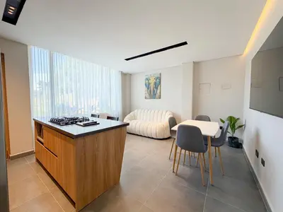 a kitchen and living room with a table and chairs at Apartamento de lujo a 3 minutos del Aeropuerto JMC 202 in Rionegro