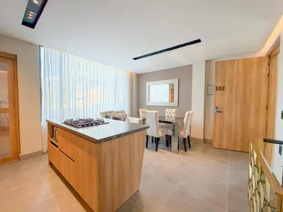 a kitchen with a table and a dining room at Apartamento de lujo a 3 minutos del Aeropuerto JMC 102 in Rionegro