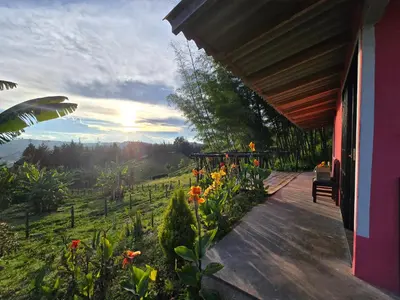 a porch of a house with a view of a field at Finca La Preciosura in El Peñol