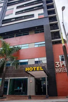a hotel building with a hotel sign in front of it at 3H hotel centro histórico in Medellín