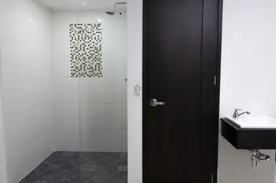 a bathroom with a glass shower and a sink at 3H hotel centro histórico in Medellín