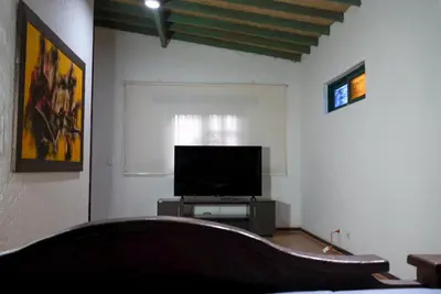 a living room with a flat screen tv and a couch at Portofino mountain retreat near Medellín in Envigado