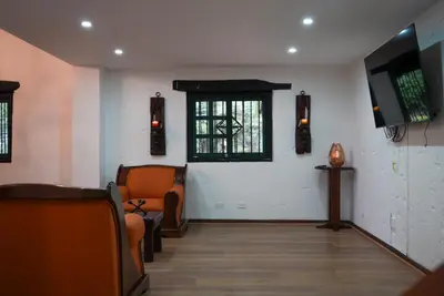 a waiting room with chairs and a tv on a wall at Portofino mountain retreat near Medellín in Envigado