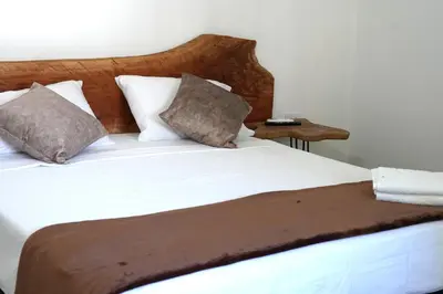 a large bed with white sheets and pillows at El Cortijo