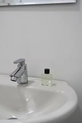 a bathroom sink with a bottle of soap on it at El Cortijo