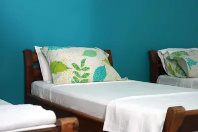 a bedroom with two twin beds with blue walls at El Cortijo