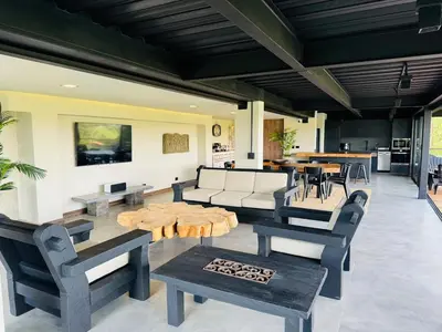 a living room with couches and chairs and a table at Exclusive Villa - Lake View - Forest in La Pradera