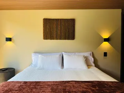a bedroom with a bed with two white pillows at Exclusive Villa - Lake View - Forest in La Pradera