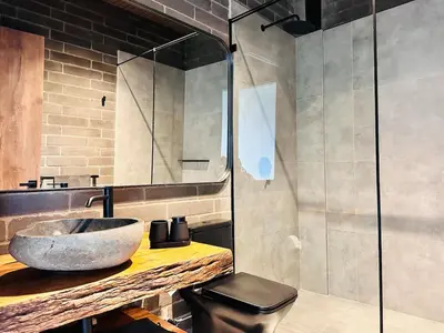 a bathroom with a sink and a glass shower at Exclusive Villa - Lake View - Forest in La Pradera