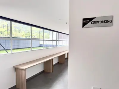 an empty corridor in a building with windows at Apartamento completo en Sabaneta in Sabaneta