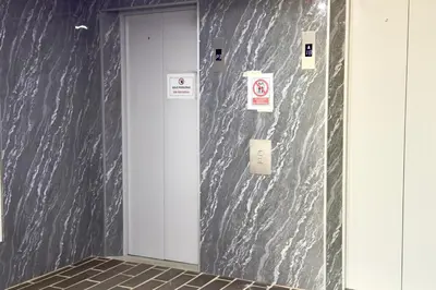 a door in a building with signs on the wall at Apartamento completo en Sabaneta in Sabaneta