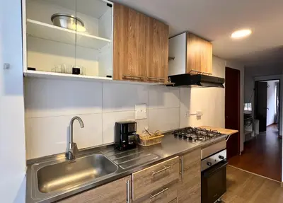 a kitchen with a sink and a stove at Dúplex familiar cerca al Cable y Milán con patio in Manizales