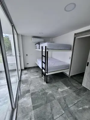 a room with a bunk bed and a tiled floor at Nautica Resort in Sopetran