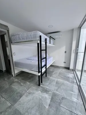 a room with two bunk beds and a tiled floor at Nautica Resort in Sopetran
