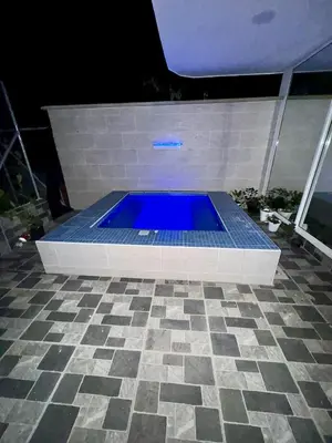 a blue swimming pool in a tile floor at Nautica Resort in Sopetran