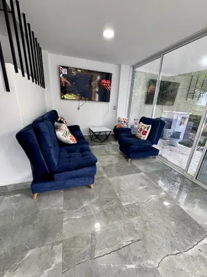 a living room with two blue couches and large windows at Nautica Resort in Sopetran