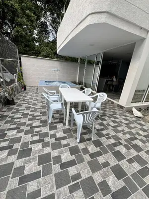a patio with a table and chairs on a tile floor at Nautica Resort in Sopetran