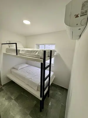 two bunk beds in a room with a window at Nautica Resort in Sopetran