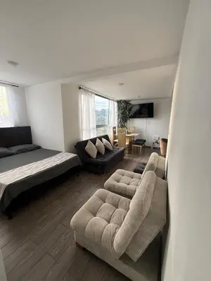 a living room with a couch and a bed at Simplemente en Casa! in Manizales