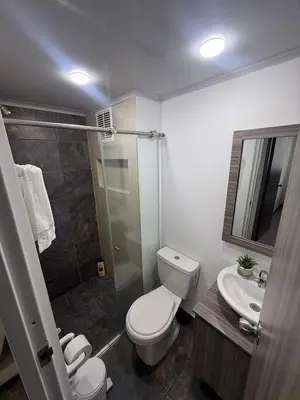a bathroom with a toilet and a shower and a sink at Simplemente en Casa! in Manizales